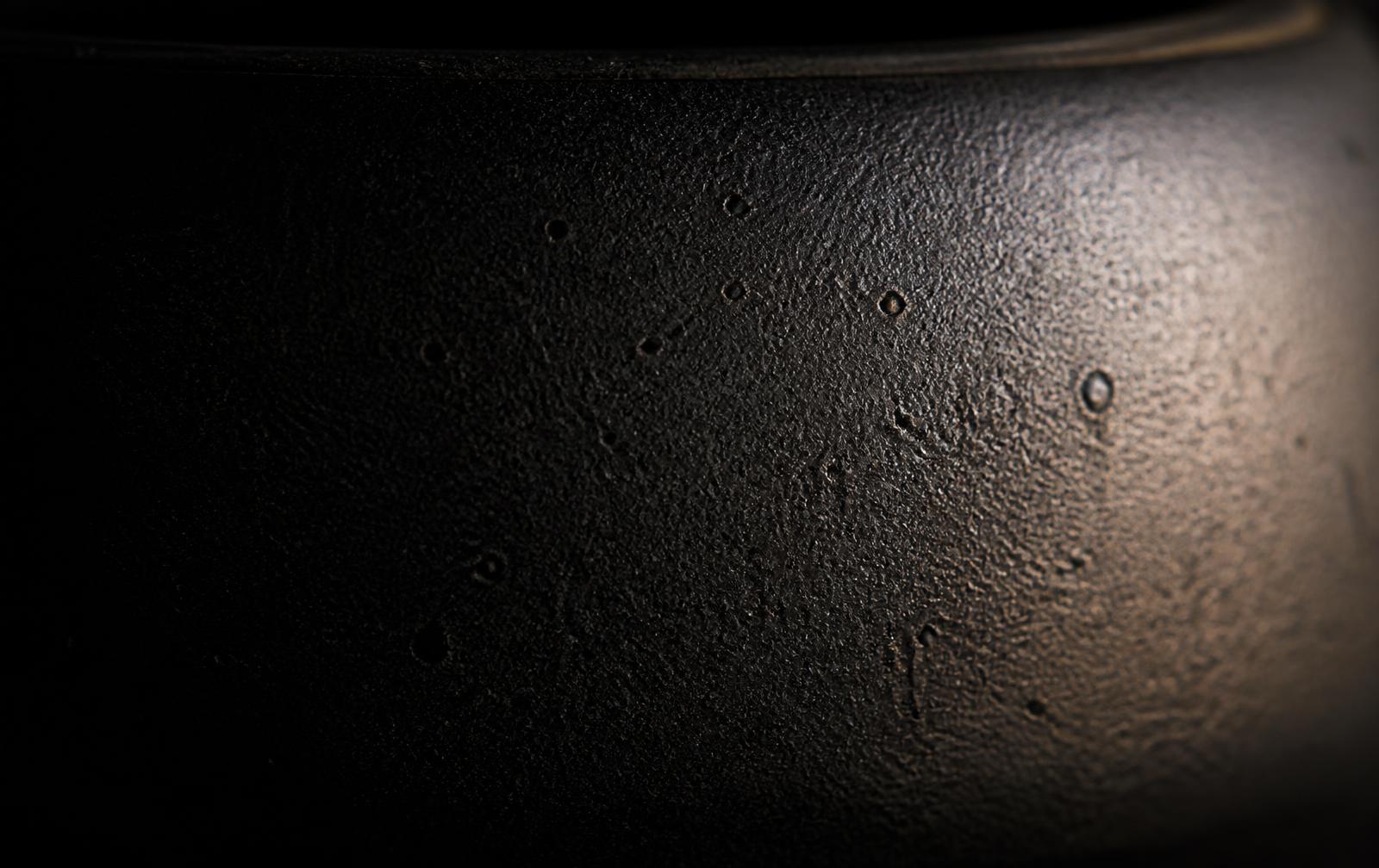 Macro detail of the thick black ceramic body